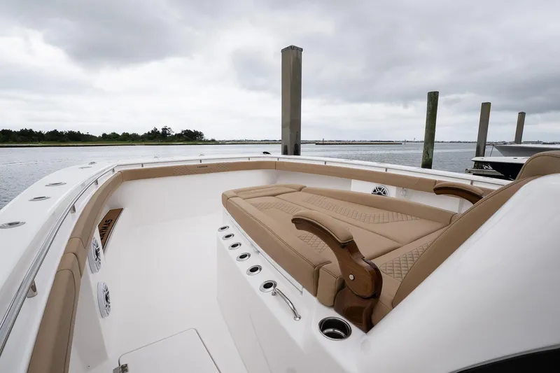 Slide: The Image of 2025 Caymas 44 CT boat with tan seating, docked on a cloudy day. - 35