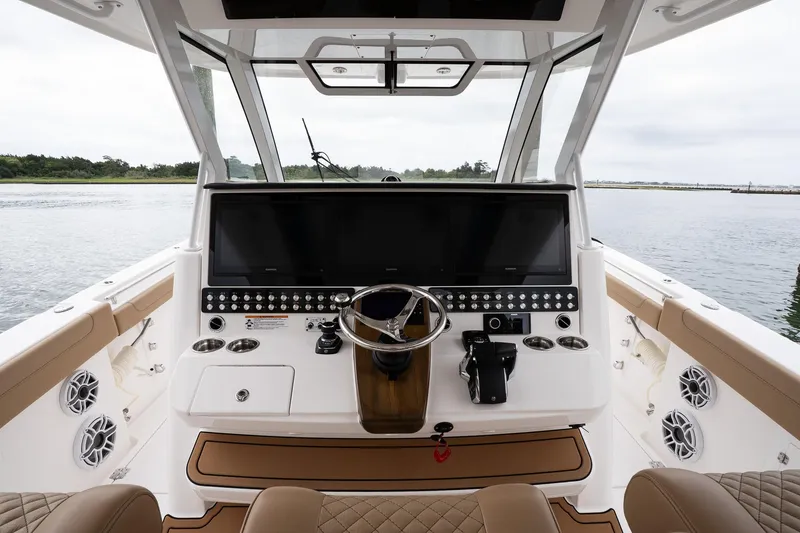 Slide: The Image of 2025 Caymas 44 CT boat cockpit with modern controls and panoramic water view. - 36