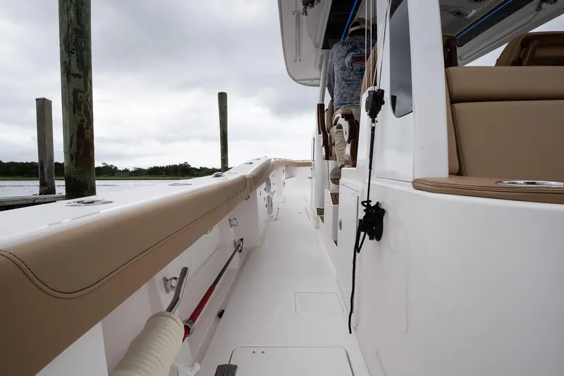 Slide: The Image of 2025 Caymas 44 CT boat deck with beige seating and overcast sky. - 37