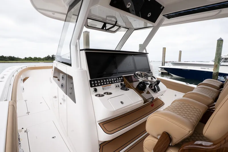 Slide: The Image of 2025 Caymas 44 CT boat cockpit with modern controls and luxurious seating. - 39