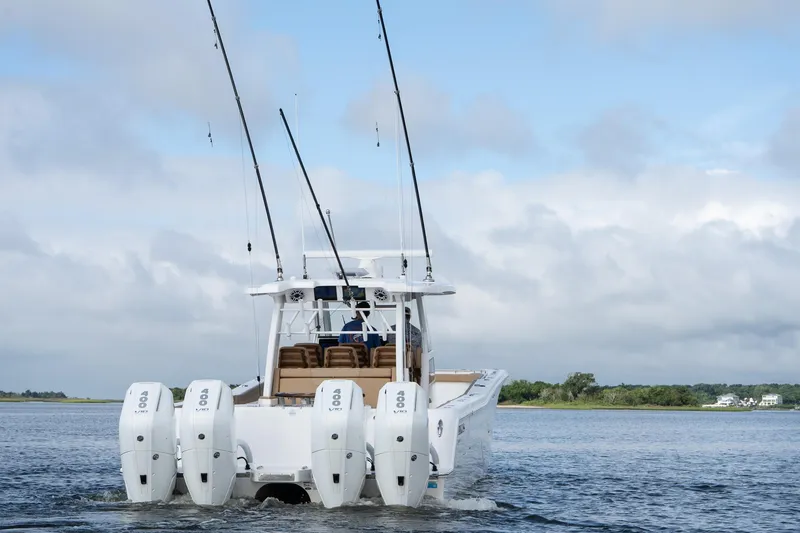 Slide: The Image of 2025 Caymas 44 CT boat with multiple outboard engines on open water. - 4