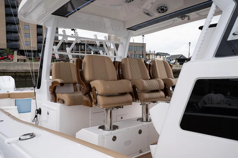Slide: The Image of Luxurious seating on 2025 Caymas 44 CT boat, docked in a marina. - 42