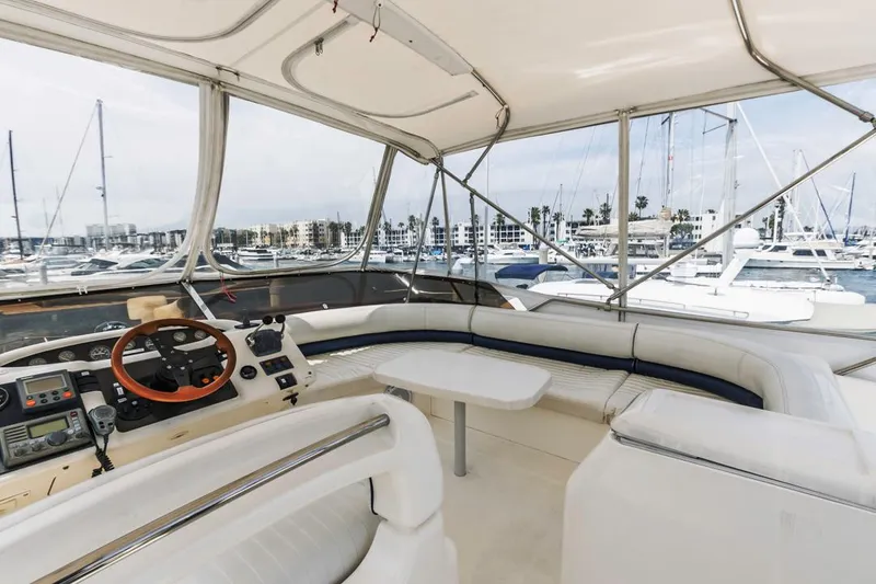 Slide: The Image of Flybridge view of 2000 Viking 46 Sport Cruiser, featuring spacious seating and marina backdrop. - 15