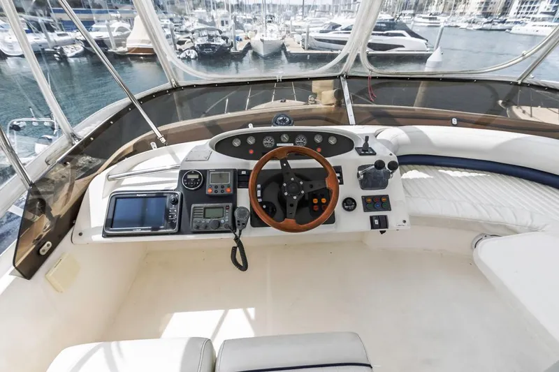 Slide: The Image of Cockpit of 2000 Viking 46 Flybridge Sport Cruiser with steering wheel and navigation equipment. - 17
