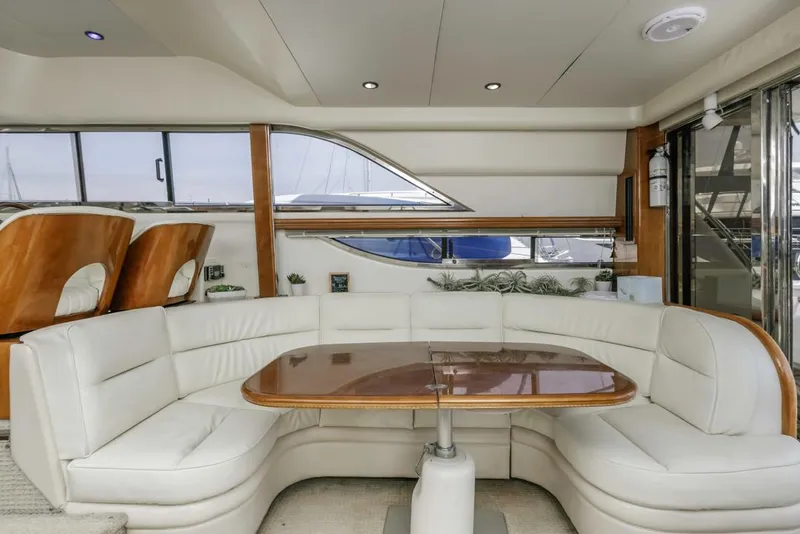 Slide: The Image of Luxurious interior of 2000 Viking 46 Flybridge Sport Cruiser with elegant seating and table. - 22