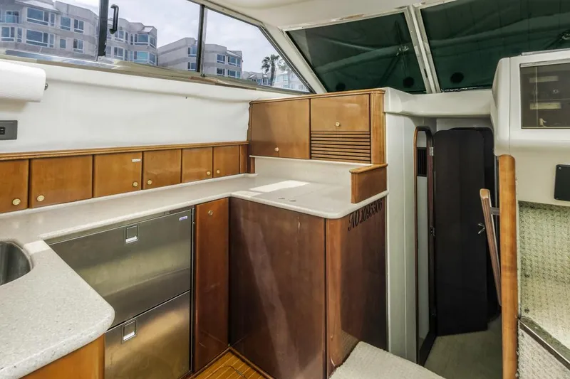 Slide: The Image of Interior of 2000 Viking 46 Flybridge Sport Cruiser with modern kitchen cabinetry. - 27