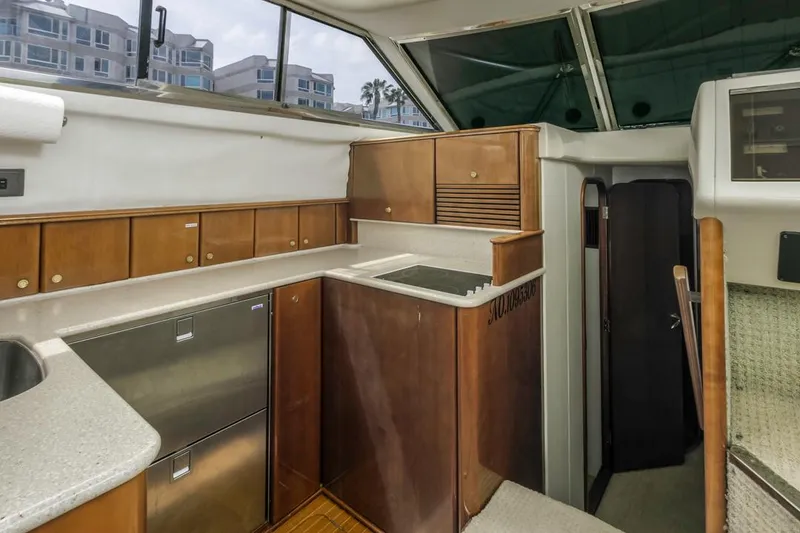 Slide: The Image of Interior of 2000 Viking 46 Flybridge Sport Cruiser with wood cabinetry and modern appliances. - 29
