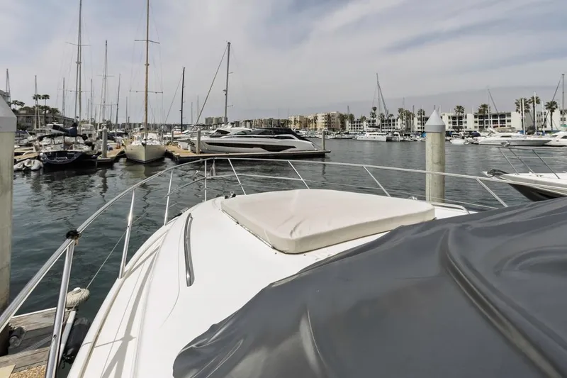Slide: The Image of 2000 Viking 46 Flybridge Sport Cruiser docked in a marina with other boats. - 9