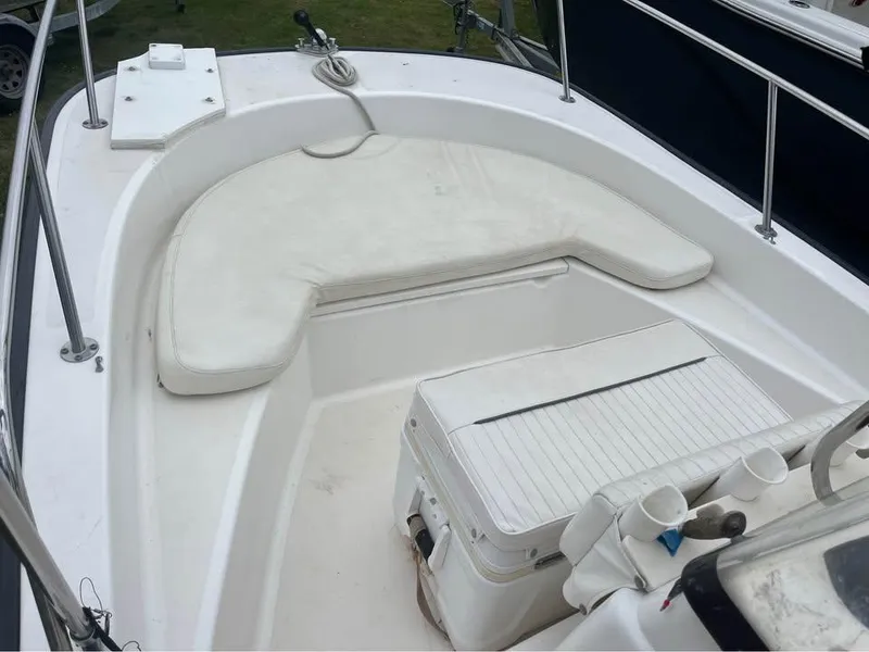 Slide: The Image of 2003 Boston Whaler 170 Montauk boat interior with cushioned seating and storage. - 10