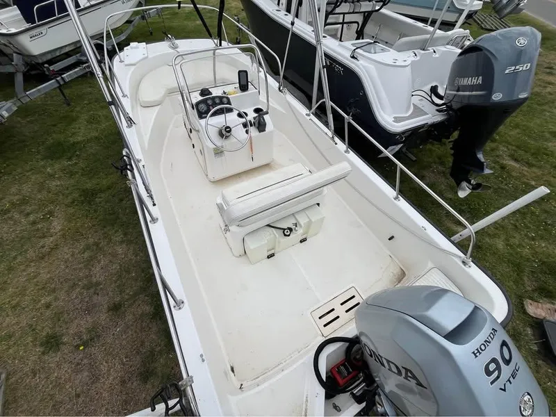 Slide: The Image of 2003 Boston Whaler 170 Montauk boat with Honda 90 VTEC engine, parked on grass. - 3