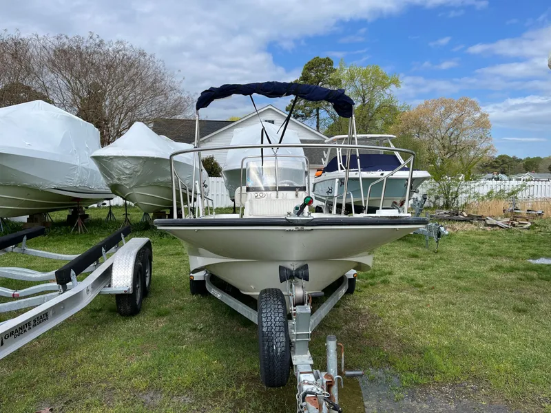 Slide: The Image of 2003 Boston Whaler 170 Montauk boat on trailer, parked outdoors under cloudy sky. - 5