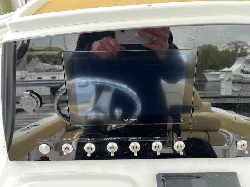 Slide: The Image of 2022 Sportsman Heritage 231 Center Console dashboard with Garmin display and control switches. - 16