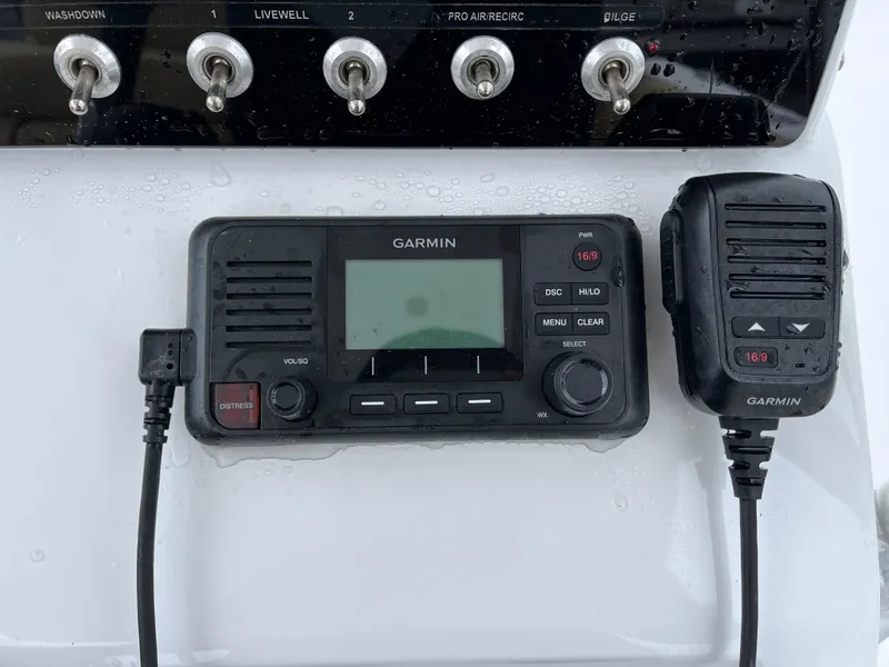 Slide: The Image of Garmin marine radio and controls on 2022 Sportsman Heritage 231 Center Console boat. - 17