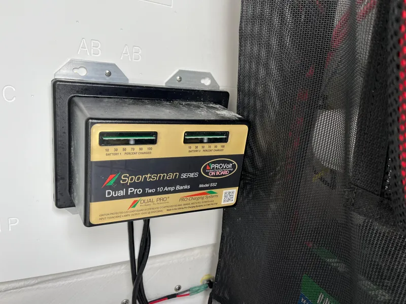 Slide: The Image of Battery charger in a 2022 Sportsman Heritage 231 Center Console boat. - 19