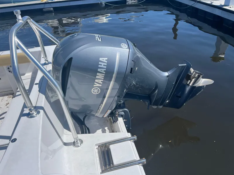 Slide: The Image of 2022 Sportsman Heritage 231 Center Console with Yamaha outboard motor docked by water. - 2