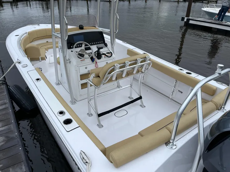 Slide: The Image of 2022 Sportsman Heritage 231 Center Console boat docked, featuring tan seating and modern controls. - 22