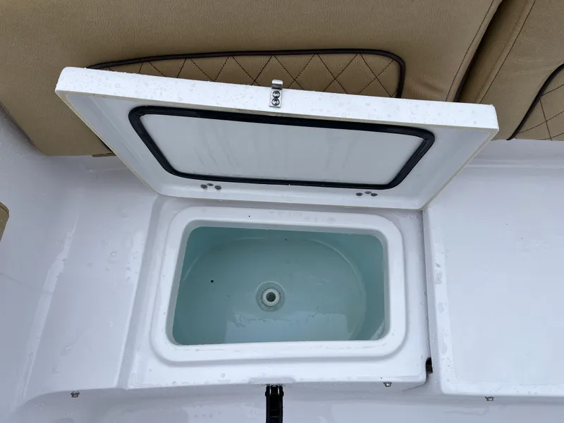 Slide: The Image of Open storage compartment on 2022 Sportsman Heritage 231 Center Console boat. - 23