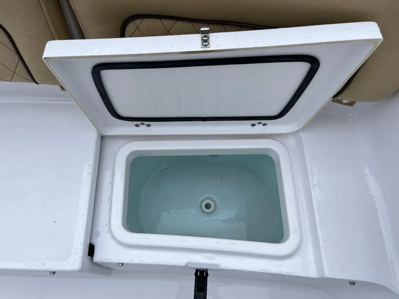 Slide: The Image of Open storage compartment on 2022 Sportsman Heritage 231 Center Console boat. - 24