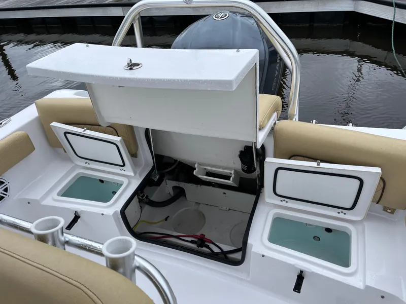 Slide: The Image of 2022 Sportsman Heritage 231 Center Console boat interior with open storage compartments. - 26