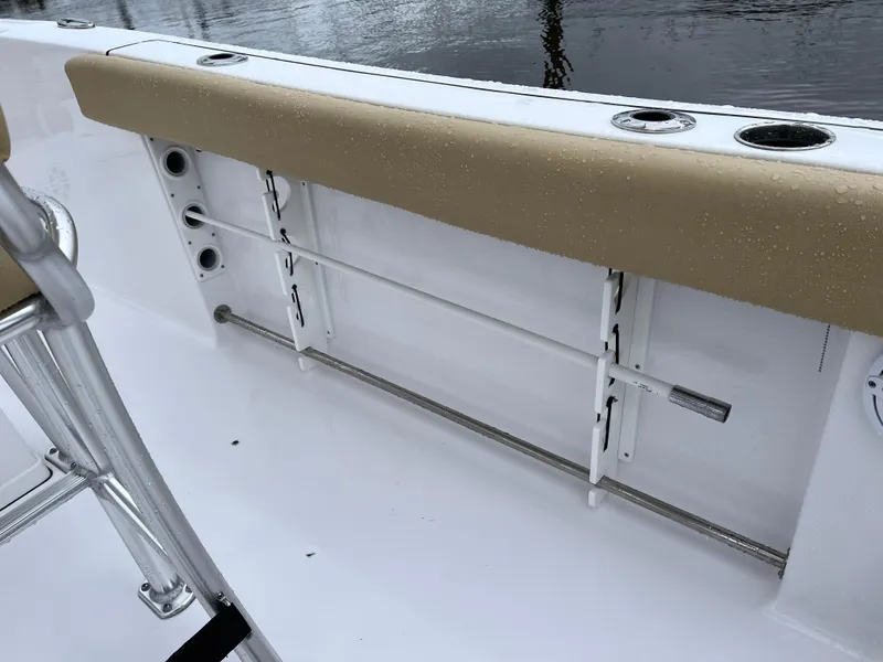 Slide: The Image of 2022 Sportsman Heritage 231 Center Console boat interior with rod holders and cushioned seating. - 27