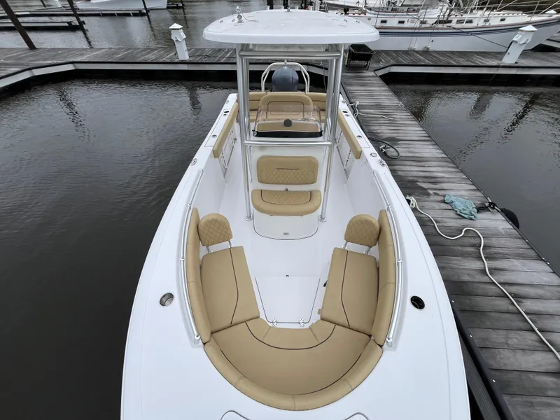 Slide: The Image of 2022 Sportsman Heritage 231 Center Console boat docked, featuring spacious seating and sleek design. - 3