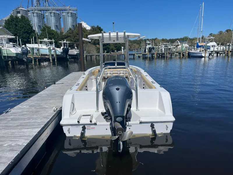 Slide: The Image of 2022 Sportsman Heritage 231 Center Console boat docked in a marina. - 30
