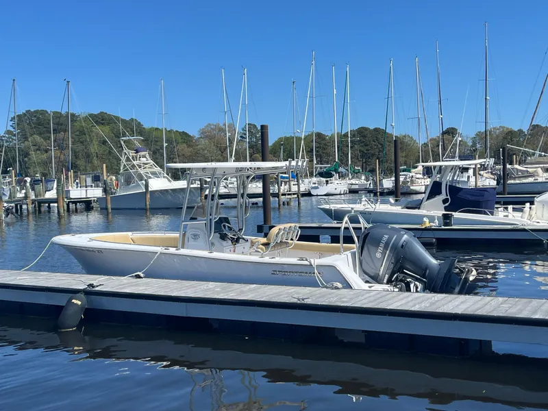Slide: The Image of 2022 Sportsman Heritage 231 Center Console boat docked at a marina. - 31