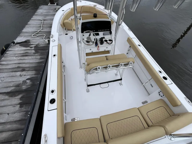 Slide: The Image of 2022 Sportsman Heritage 231 Center Console boat docked, featuring spacious seating and modern controls. - 4