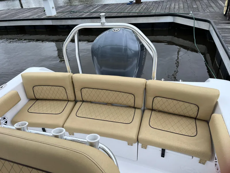 Slide: The Image of 2022 Sportsman Heritage 231 Center Console boat with tan seating at a dock. - 8