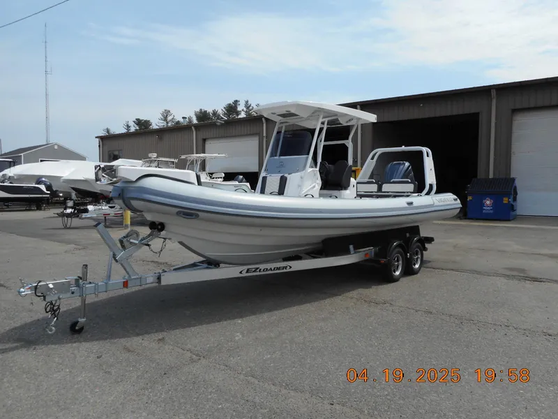 The Image of 2025 Highfield Sport 760 boat on trailer, parked outdoors near storage facility. - 1