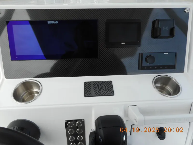 Slide: The Image of Highfield Sport 760 dashboard with Simrad display, cup holders, and controls, dated April 19, 2025. - 13