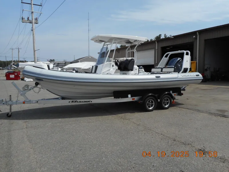 Slide: The Image of 2025 Highfield Sport 760 boat on a trailer in an industrial area. - 4