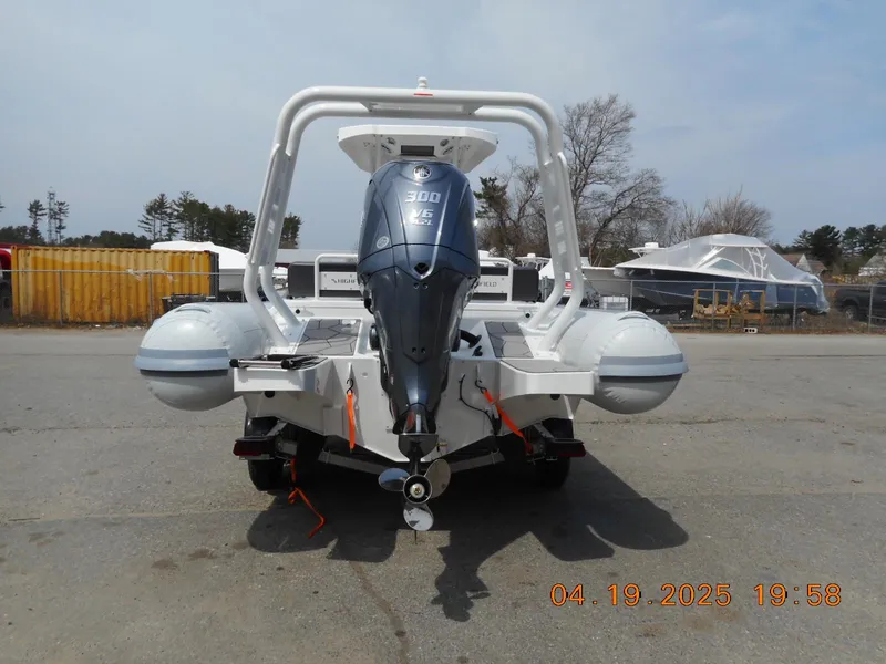 Slide: The Image of 2025 Highfield Sport 760 boat with outboard motor, parked outdoors on a clear day. - 5