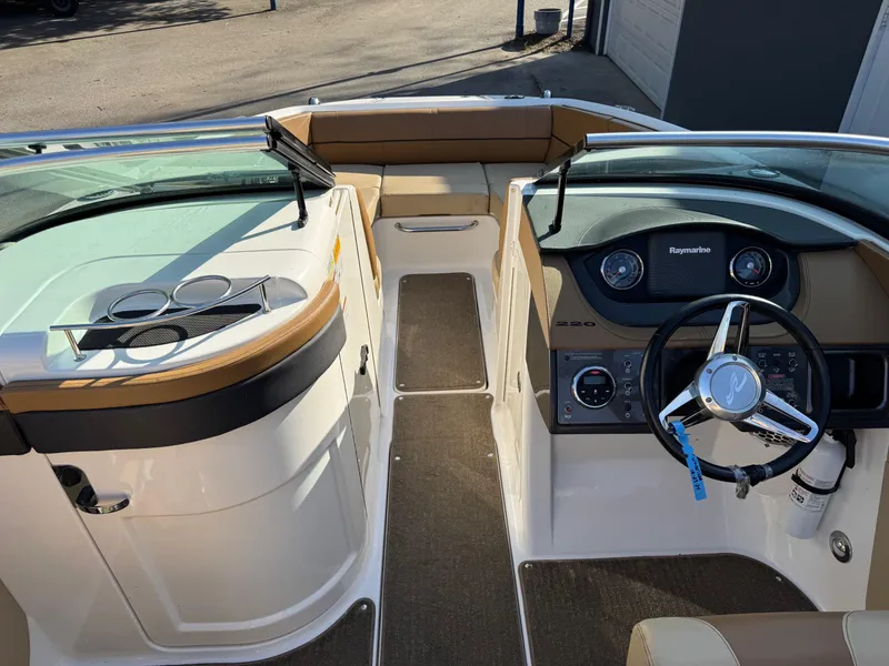 Slide: The Image of 2015 Sea Ray 220 Sundeck interior with steering wheel and dashboard view. - 11