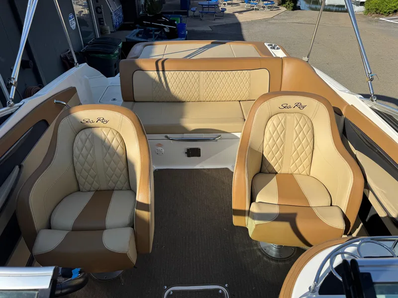 Slide: The Image of 2015 Sea Ray 220 Sundeck interior with tan leather seating and elegant design. - 14