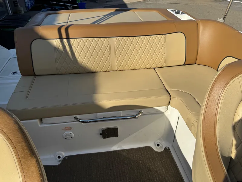 Slide: The Image of 2015 Sea Ray 220 Sundeck interior with tan leather seating and diamond stitching. - 15