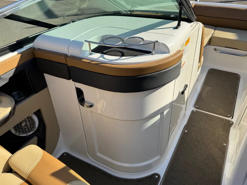 Slide: The Image of 2015 Sea Ray 220 Sundeck interior with cup holders and seating area. - 18