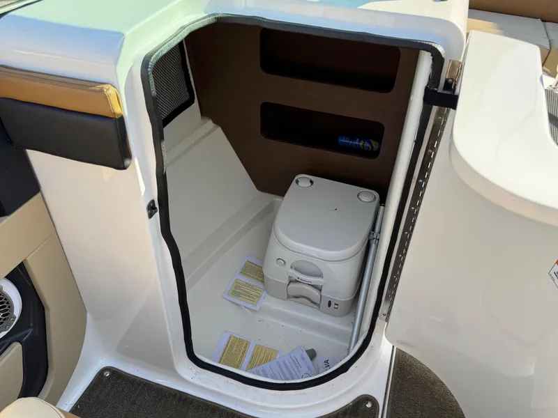 Slide: The Image of 2015 Sea Ray 220 Sundeck boat interior with compact toilet compartment. - 19