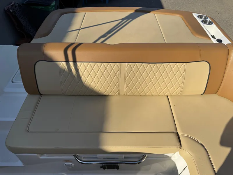 Slide: The Image of 2015 Sea Ray 220 Sundeck boat seat with tan upholstery and diamond stitching. - 21