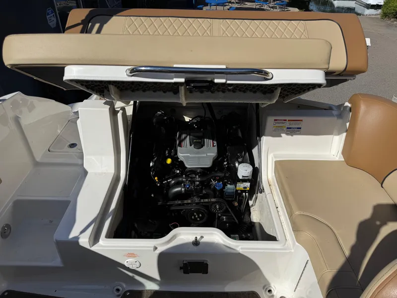 Slide: The Image of 2015 Sea Ray 220 Sundeck boat engine compartment with open hatch, showcasing interior mechanics. - 6