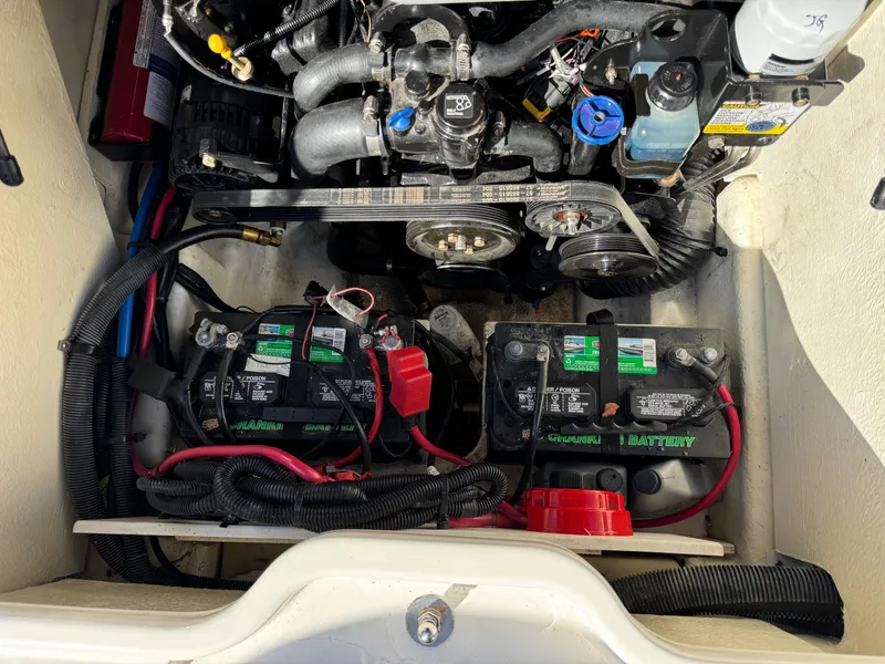 Slide: The Image of Engine compartment of a 2015 Sea Ray 220 Sundeck with dual batteries and visible wiring. - 7
