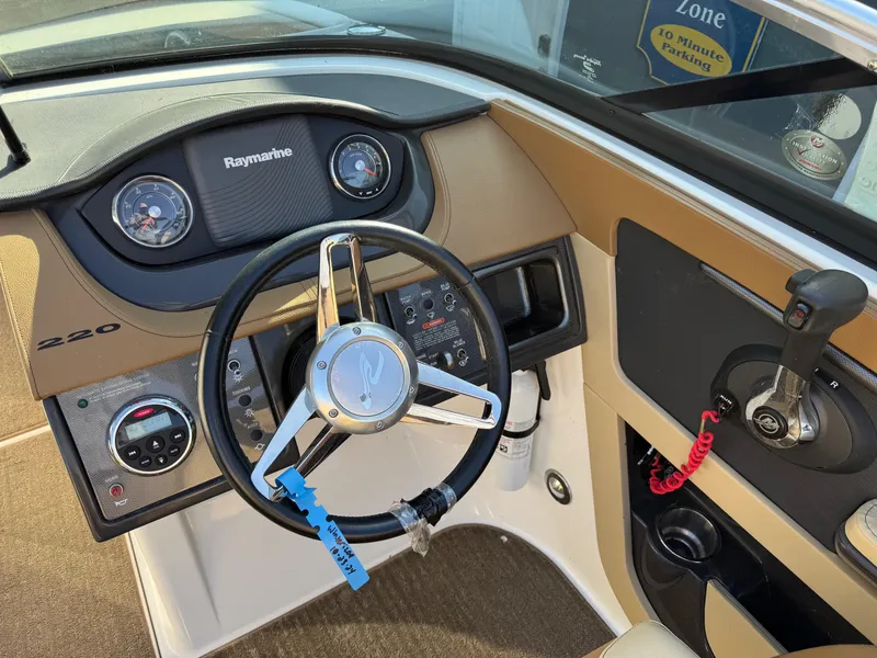Slide: The Image of Steering console of 2015 Sea Ray 220 Sundeck with Raymarine gauges and controls. - 9
