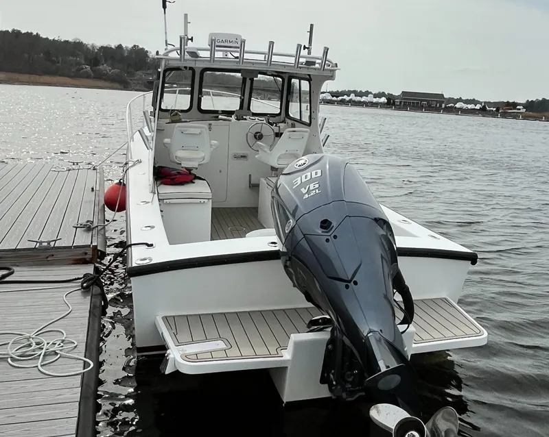 Slide: The Image of 2007 Eastern 27 boat docked, featuring a powerful 300 HP outboard motor. - 10
