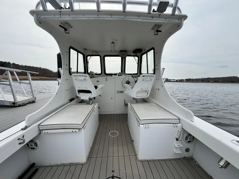 Slide: The Image of 2007 Eastern 27 boat interior with dual seats and open water view. - 12