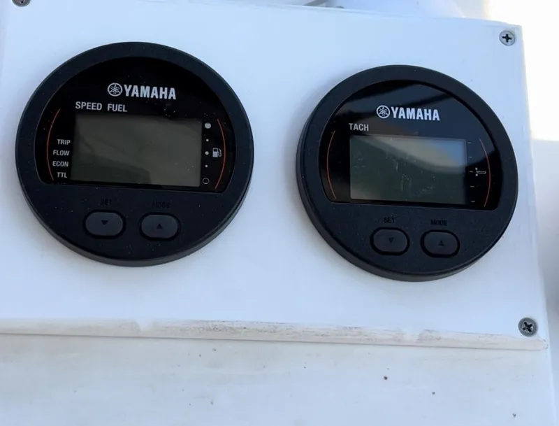 Slide: The Image of Yamaha speed fuel and tachometer gauges on a 2007 Eastern 27 boat dashboard. - 17