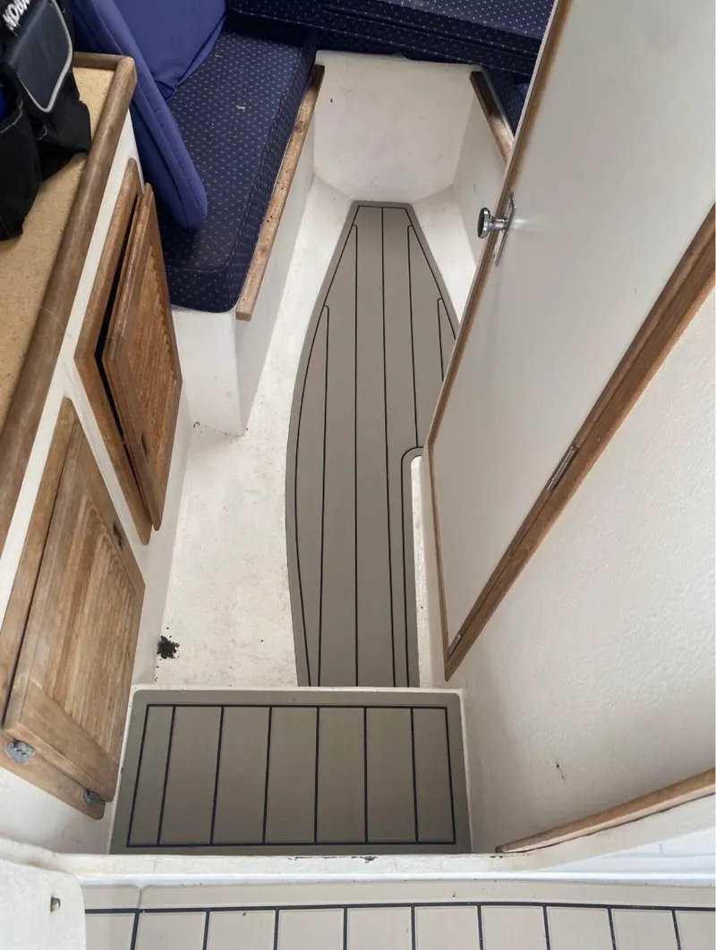Slide: The Image of Interior of a 2007 Eastern 27 boat with wood accents and gray flooring. - 21
