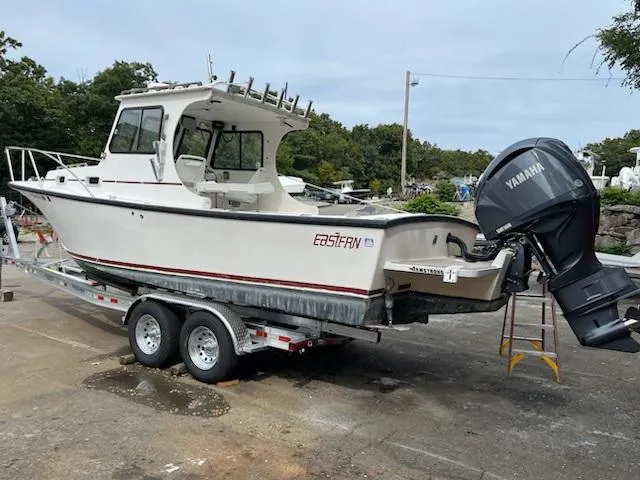 Slide: The Image of 2007 Eastern 27 boat on trailer with Yamaha outboard motor, parked outdoors. - 3