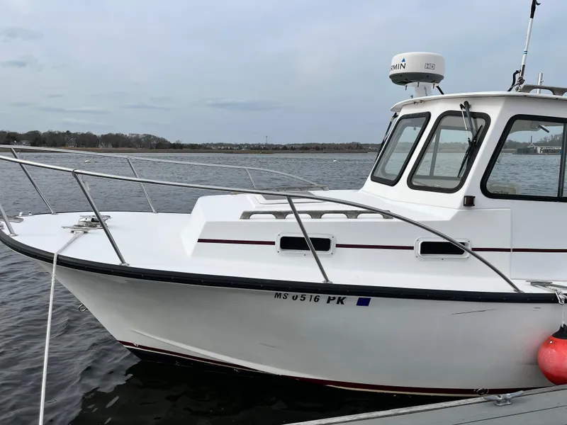 Slide: The Image of 2007 Eastern 27 boat on water, white hull, enclosed cabin, radar on top. - 4