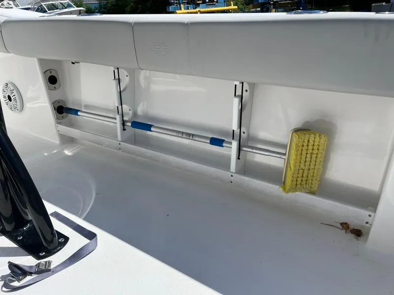 Slide: The Image of 2021 Sea Fox 248 Commander boat interior with storage compartment and cleaning brush. - 14