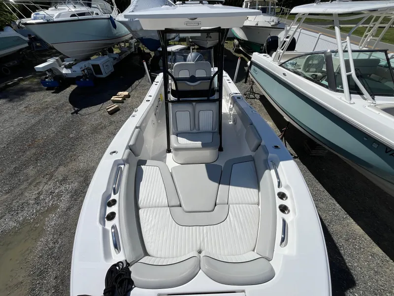 Slide: The Image of 2021 Sea Fox 248 Commander boat with spacious seating and modern design, docked among other boats. - 2